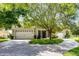 Charming home featuring a three car garage, a circular driveway, and lush landscaping at 9104 Stromboli Ct, Kissimmee, FL 34747