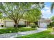 Beautiful home featuring a paved driveway, mature landscaping, and a three car garage at 9104 Stromboli Ct, Kissimmee, FL 34747