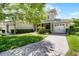 Home featuring a paved driveway, well manicured landscaping, and a three car garage at 9104 Stromboli Ct, Kissimmee, FL 34747