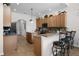 Spacious kitchen featuring granite countertops, stainless steel appliances, a breakfast bar, and ample cabinet space at 9104 Stromboli Ct, Kissimmee, FL 34747