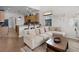 Open-concept living room with a large sofa, breakfast bar, and kitchen in the background at 9104 Stromboli Ct, Kissimmee, FL 34747