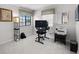 Office room with a computer, printer and large windows allowing ample natural light during the daytime at 9104 Stromboli Ct, Kissimmee, FL 34747