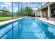 A large pool in a screened enclosure featuring patio and beautiful backyard at 9104 Stromboli Ct, Kissimmee, FL 34747