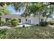 Well-maintained backyard with a concrete patio and views of the home's exterior at 1016 Seminole Creek Dr, Oviedo, FL 32765