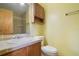 Cozy bathroom featuring a tiled countertop, wooden vanity, and matching medicine cabinet at 1016 Seminole Creek Dr, Oviedo, FL 32765