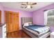 Comfortable bedroom with a ceiling fan, wood floors, and a gray, upholstered headboard at 1016 Seminole Creek Dr, Oviedo, FL 32765