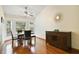 Bright dining room with hardwood floors, natural light from a bay window, and an elegant wooden sideboard at 1016 Seminole Creek Dr, Oviedo, FL 32765