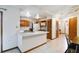 Functional kitchen featuring light countertops, wood cabinets, and direct access to the dining and living areas at 1016 Seminole Creek Dr, Oviedo, FL 32765