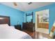 Comfortable main bedroom showing hardwood floors with a view to ensuite bathroom with a double vanity at 1016 Seminole Creek Dr, Oviedo, FL 32765