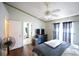 Bright bedroom boasts wood-look floors, ceiling fan, and ensuite bathroom access at 10255 Cody Ln, Orlando, FL 32825