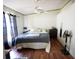 Relaxing bedroom with wood-look floors, crown moulding, and neutral paint at 10255 Cody Ln, Orlando, FL 32825
