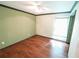 An empty bedroom featuring wood floors, and neutral-colored walls with white trim at 10255 Cody Ln, Orlando, FL 32825