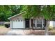 Charming single-story home with well-maintained lawn, garage, and inviting front porch at 10255 Cody Ln, Orlando, FL 32825
