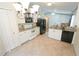 Well-equipped kitchen with white cabinets, granite countertops, and stainless steel appliances at 10255 Cody Ln, Orlando, FL 32825