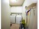 Practical laundry room features a washer, dryer, storage cabinets, and convenient cleaning supply organization at 10255 Cody Ln, Orlando, FL 32825
