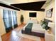 Cozy bedroom with hardwood floors, a bed with accent pillows, and natural light from the window at 10255 Cody Ln, Orlando, FL 32825