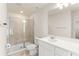 Bathroom showcasing a glass enclosed shower, white vanity, and a large mirror at 10959 Vesper Aly, Orlando, FL 32829