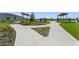 Inviting community area with sidewalks, landscaping, playground, picnic tables, and artificial turf at 10959 Vesper Aly, Orlando, FL 32829
