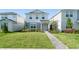 Beautiful two-story home with green lawn and landscaped pathway to the front door at 10959 Vesper Aly, Orlando, FL 32829