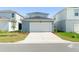 This home's large, two car garage provides ample parking space and curb appeal with a clean design at 10959 Vesper Aly, Orlando, FL 32829