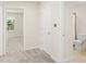 Hallway with three doorways leading to rooms including a full bathroom at 10959 Vesper Aly, Orlando, FL 32829
