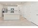 Bright kitchen with island, white cabinets, stainless appliances, and tile floors at 10959 Vesper Aly, Orlando, FL 32829