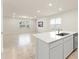 Open-concept kitchen and living area with island, tile floors, and modern finishes at 10959 Vesper Aly, Orlando, FL 32829