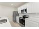 Kitchen featuring stainless steel appliances, modern cabinets, and sleek countertops at 10959 Vesper Aly, Orlando, FL 32829