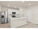 Modern kitchen featuring white cabinets, stainless steel appliances, and a large island at 10959 Vesper Aly, Orlando, FL 32829