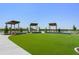 Inviting outdoor area featuring covered seating, manicured lawn, and a scenic view with a central fountain at 10959 Vesper Aly, Orlando, FL 32829