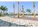 Outdoor community pool with lounge areas and palm trees, near a neighborhood of modern homes at 10959 Vesper Aly, Orlando, FL 32829