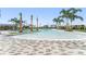 Large community pool with lounge areas and many palm trees, for a luxury outdoor experience at 10959 Vesper Aly, Orlando, FL 32829