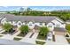 Aerial view of townhomes, showing garages, neutral paint scheme, landscaping and well-maintained community at 1109 Pavia Dr, Apopka, FL 32703