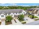 Aerial view of townhomes, showing garages, neutral paint scheme, landscaping and well-maintained community at 1109 Pavia Dr, Apopka, FL 32703