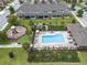 Aerial view of community pool, playground, lounge chairs, and recreation center surrounded by green space at 1109 Pavia Dr, Apopka, FL 32703