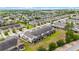 Aerial view of townhomes, showing garages, neutral paint scheme, landscaping and well-maintained community at 1109 Pavia Dr, Apopka, FL 32703