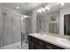 Modern bathroom featuring a glass-enclosed shower and double sink vanity with dark wood cabinets at 1109 Pavia Dr, Apopka, FL 32703