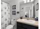Cozy bathroom boasts a shower with nautical-themed decor and single sink vanity at 1109 Pavia Dr, Apopka, FL 32703