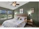 Comfortable bedroom featuring large windows, a ceiling fan, and modern furnishings and decor at 1109 Pavia Dr, Apopka, FL 32703