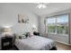 Bright bedroom featuring a ceiling fan, large window with backyard view, and modern decor at 1109 Pavia Dr, Apopka, FL 32703