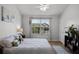 Bright bedroom featuring a ceiling fan, large window with backyard view, and modern decor at 1109 Pavia Dr, Apopka, FL 32703