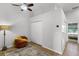 Bright bedroom featuring a ceiling fan, closet, and an orange chair atop a colorful rug on hardwood floors at 1109 Pavia Dr, Apopka, FL 32703