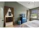 Comfortable bedroom leading to ensuite bath with a TV console, curtains and large windows at 1109 Pavia Dr, Apopka, FL 32703