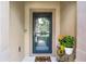 Welcoming entryway with a decorative welcome mat and potted plants at 1109 Pavia Dr, Apopka, FL 32703