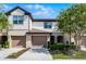 Inviting townhome with a two-car garage and beautifully landscaped front yard at 1109 Pavia Dr, Apopka, FL 32703