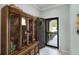 Inviting foyer with tile flooring and a classic wooden china cabinet at 1109 Pavia Dr, Apopka, FL 32703