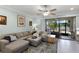 Comfortable living room with a plush sectional sofa and access to the patio at 1109 Pavia Dr, Apopka, FL 32703