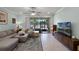 Comfortable living room with a large sliding glass door that provides access to outdoor space at 1109 Pavia Dr, Apopka, FL 32703