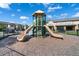 Outdoor play structure with slides surrounded by a fenced in mulch area with nearby homes at 1109 Pavia Dr, Apopka, FL 32703