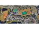 Aerial view of community with a baseball field, playground, tennis courts and a pond at 12212 Wild Iris Way # 106, Orlando, FL 32837